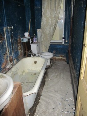 Delapidated wreck of a bathroom in a Harlem townhouse