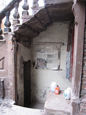 Two entrances under a brownstone stoop in Harlem