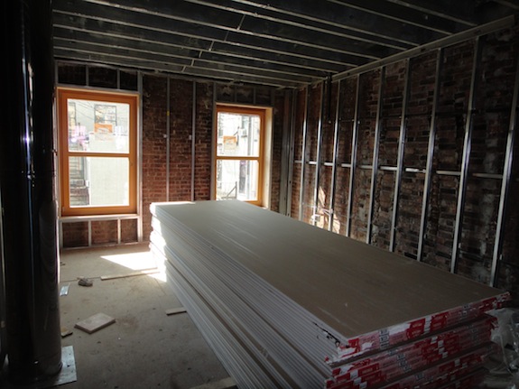 Piles of drywall in a townhouse under renovation