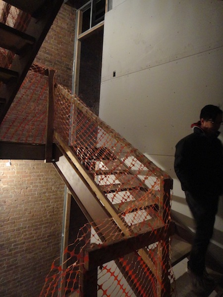 Dan in stairwell with drywall going up